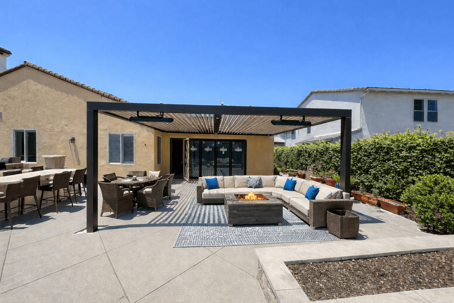 Modern outdoor patio with a pergola and cozy seating area.