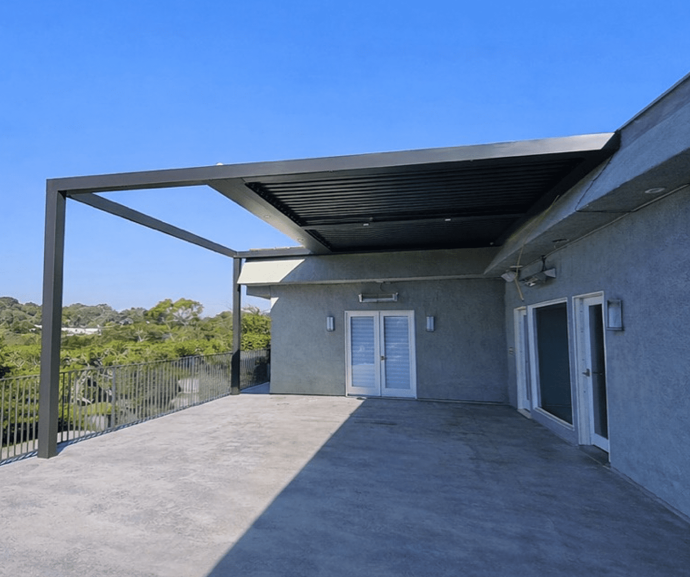 Spacious rooftop terrace with modern pergola and scenic views.